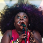 Tarriona Ball (aka Tank), a singer and poet who fronts the band Tank and the Bangas, sings into the microphone at the french quarter festival in 2014.